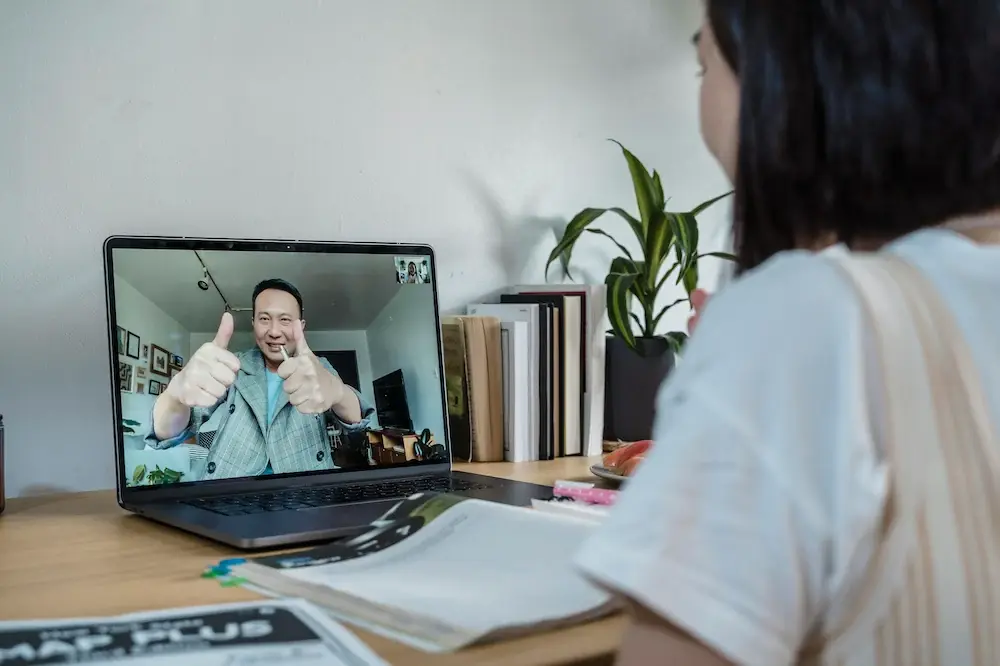 A Telos tutor on a video call with a student